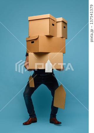 Shopper carrying stack of cardboard boxes with price tags sale 137541379