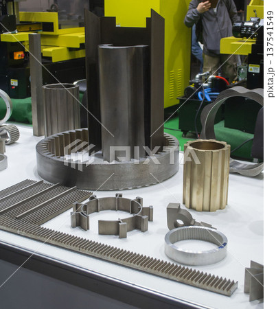 Different metal models on a white surface. Many metal products close-up. Various metal parts of gear transmissions. Gear wheels. Metal processing. Industrial metalworking objects. Steel manufacturing Different metal models on a white surface. Many metal products close-up. Various metal parts of gear transmissions. Gear wheels. Metal processing. Industrial metalworking objects. Steel manufacturing 137541549