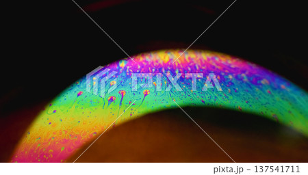 Rainbow curve. Defocused gasoline fluid. Soap fluorescent mix glow arch on black background. Abstract color neon gradient ink copy space. Rainbow curve. Defocused gasoline fluid. Soap fluorescent mix glow arch on black background. Abstract color neon gradient ink copy space. 137541711