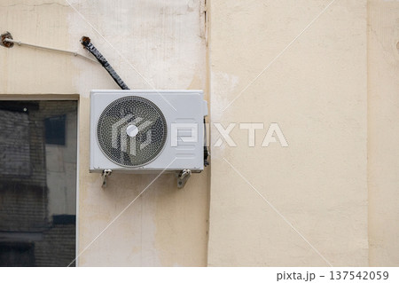 air conditioning on facade of building, air cooling in hot weather. air conditioning on facade of building, air cooling in hot weather. 137542059