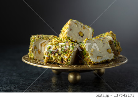 Turkish delights with pistachio in golden dish. Turkish delights with pistachio in golden dish. 137542173