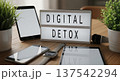 Lightbox displaying digital detox message on wooden desk 137542294