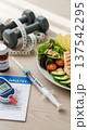 Healthy lifestyle flatlay with insulin injection glucose meter dumbbells measuring tape and balanced salad for wellness background and fitness poster 137542295