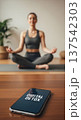 Smartphone screen showing "digital detox" with a woman meditating in the background for wellness poster and mindfulness background 137542303