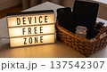 Lightbox device free zone sign with basket of phones tablets and earbuds for home office wellness corner and declutter reminder 137542307