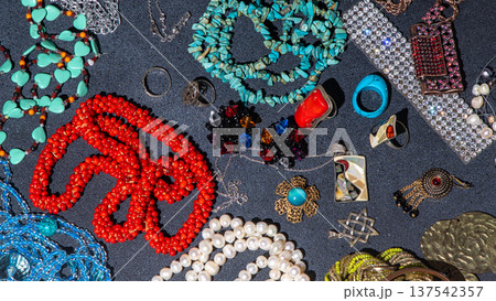 Jewelry accessories turquoise beads, pearl necklaces, coral pieces, silver rings background. Treasure top view 137542357