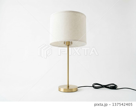 Minimalist Table Lamp with Cylindrical Fabric Shade and Brass Metal Base on White Background Minimalist Table Lamp with Cylindrical Fabric Shade and Brass Metal Base on White Background 137542405