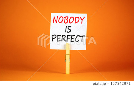 Nobody is perfect symbol. Concept words Nobody is perfect on beautiful white paper on clothespin. Beautiful orange background. Business motivational lifestyle and nobody is perfect concept. Copy space Nobody is perfect symbol. Concept words Nobody is perfect on beautiful white paper on clothespin. Beautiful orange background. Business motivational lifestyle and nobody is perfect concept. Copy space 137542971