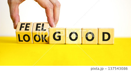 Look and feel good symbol. Concept words Look good Feel good on wooden cubes. Beautiful yellow table white background. Doctor hand. Healthy lifestyle look and feel good concept. Copy space. Look and feel good symbol. Concept words Look good Feel good on wooden cubes. Beautiful yellow table white background. Doctor hand. Healthy lifestyle look and feel good concept. Copy space. 137543086