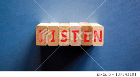 Listen symbol. Concept word Listen on beautiful wooden blocks. Beautiful blue background. Business education listen concept. Copy space. 137543101