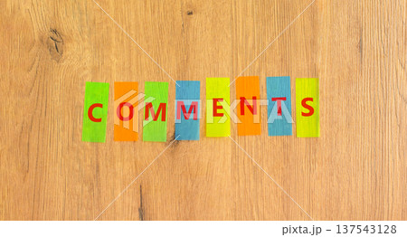 Comments comment word symbol. Concept word Comments on beautiful colored papers. Beautiful wooden background. Business support help comments comment word concept. Copy space. 137543128