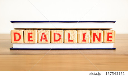 Deadline word symbol. Concept word Deadline on beautiful wooden blocks in beautiful book. Beautiful wooden table white background. Business support help deadline word concept. Copy space. Deadline word symbol. Concept word Deadline on beautiful wooden blocks in beautiful book. Beautiful wooden table white background. Business support help deadline word concept. Copy space. 137543131