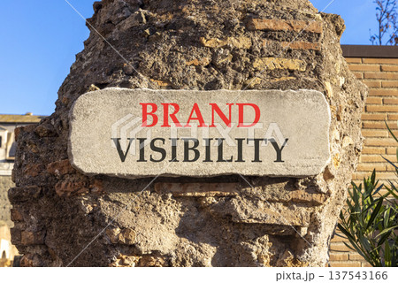 Brand visibility symbol. Concept words Brand visibility on beautiful big white sign plate. Beautiful old brown brick wall blue sky background. Business branding brand visibility concept. Copy space. 137543166