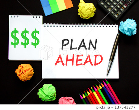 Plan ahead symbol. Concept word Plan ahead on beautiful white note. Black calculator. Black pen. Beautiful black paper background. Business plan ahead concept. Copy space. Plan ahead symbol. Concept word Plan ahead on beautiful white note. Black calculator. Black pen. Beautiful black paper background. Business plan ahead concept. Copy space. 137543277