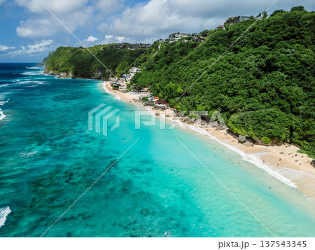 Tropical beach with turquoise sea in Bali. Drone view of popular holidays place Tropical beach with turquoise sea in Bali. Drone view of popular holidays place 137543345