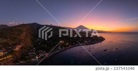 Panorama view of coastline with silhouette of volcano at sunset in Bali. Panorama view of coastline with silhouette of volcano at sunset in Bali. 137543346