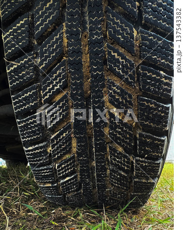 close-up of car tire treads in mud. Vertical image 137543382