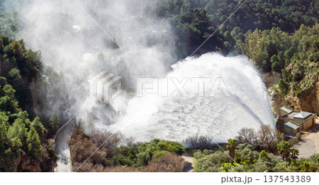 Dramatic emergency water release cascading from a reservoir after heavy rains creating powerful natural scenery in Spain. Dramatic emergency water release cascading from a reservoir after heavy rains creating powerful natural scenery in Spain. 137543389