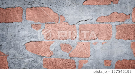 Textured wall featuring a combination of gray concrete and reddish-brown bricks, showcasing a rustic and industrial aesthetic suitable for various design applications 137545195