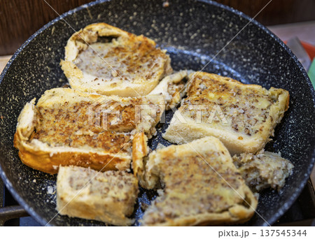 Frying slices of traditional Ukrainian Yavorivskyi pie with buckwheat and potato. Frying slices of traditional Ukrainian Yavorivskyi pie with buckwheat and potato. 137545344