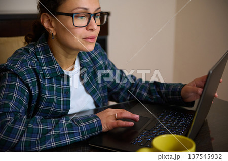 Woman Entrepreneur Working Remotely at Home in Casual Clothes Using Laptop 137545932