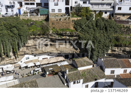 Setenil de las Bodegas shows houses built into rock with terraces and cafes below the cliffs in southern Spain Setenil de las Bodegas shows houses built into rock with terraces and cafes below the cliffs in southern Spain 137546269