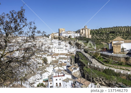 Views of Setenil de las Bodegas with white buildings and historical sites under a clear blue sky Views of Setenil de las Bodegas with white buildings and historical sites under a clear blue sky 137546270
