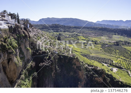 View of Ronda landscapes and cliffs with farms in southern Spain during clear weather View of Ronda landscapes and cliffs with farms in southern Spain during clear weather 137546276