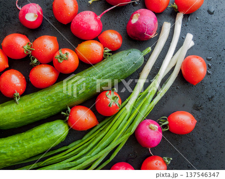 Food cooking and healthy diet, fresh ripe organic vegetables and greens lying on cutting board. Food cooking and healthy diet, fresh ripe organic vegetables and greens lying on cutting board. 137546347