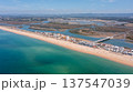 Praia de Faro along the coast in Ria Formosa, Algarve, Portugal, captured from above with clear water and land outlines on a sunny day 137547039