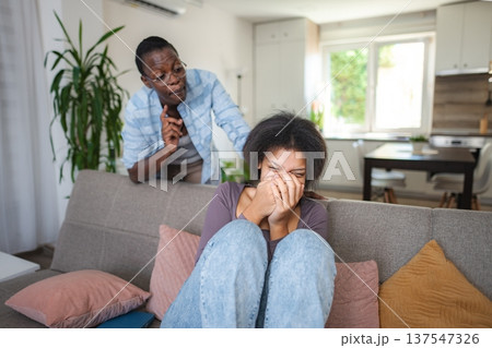 Mother comforting her crying teenage daughter at home 137547326