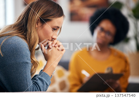Woman thinking, stress and therapy by psychologist, therapist or healthcare professional with checklist evaluation Client and therapist writing for mental health support or advice in debt or crisis 137547540