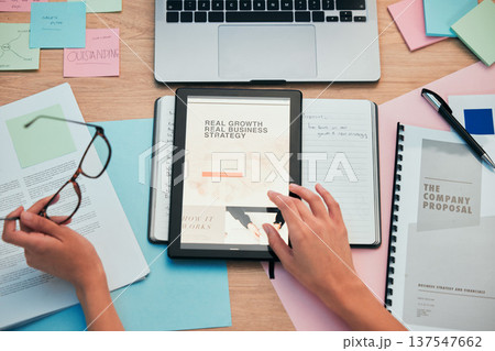 Tablet, screen and hands, company website and paperwork, business proposal and workspace. Person at desk, corporate development and digital market research strategy, sticky note and laptop top view 137547662