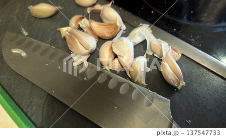 Oxtail preparation with fresh garlic and chef knife for culinary inspiration 137547733