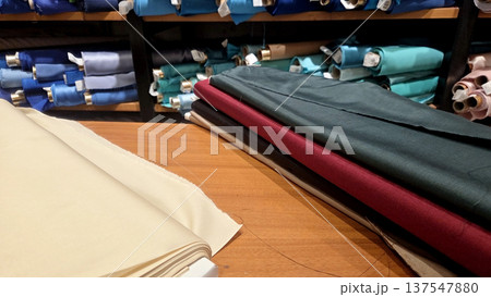 Colorful fabric selection in textile store display for sewing and design projects Colorful fabric selection in textile store display for sewing and design projects 137547880