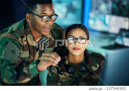 Night strategy, army and people with computer for communication, planning or surveillance of government. Cyber security, data center and black man talking to a woman about monitor in a military room 137548303