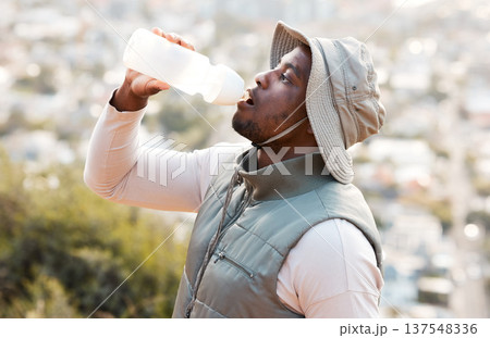 Hiking, drinking water and black man with fitness, health or hydration with workout, peace or exercise. African person, travel or hiker with bottle for liquid, thirsty or nature with wellness or aqua Hiking, drinking water and black man with fitness, health or hydration with workout, peace or exercise. African person, travel or hiker with bottle for liquid, thirsty or nature with wellness or aqua 137548336