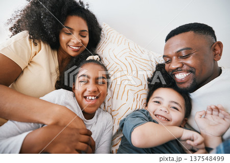 Mom, dad and kids in bed with tickling, comic joke and laugh with bonding, care and love in family home. Black man, mother and daughter with smile, playful game and crazy in bedroom, morning or house 137548499