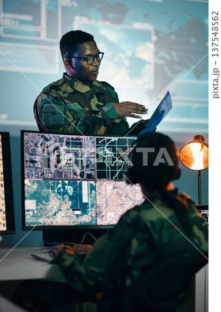 Military control room, computer and woman with team leader, headset and tech in communication. Security, surveillance management and soldier with black man in army office at government command center 137548562
