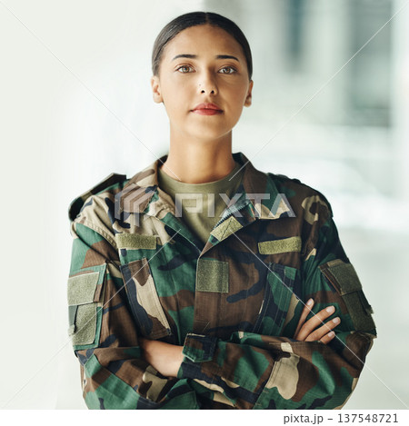Confident soldier portrait, woman and arms crossed in army building, pride and professional hero service. Military career, security and courage, proud girl in camouflage uniform at government agency. 137548721