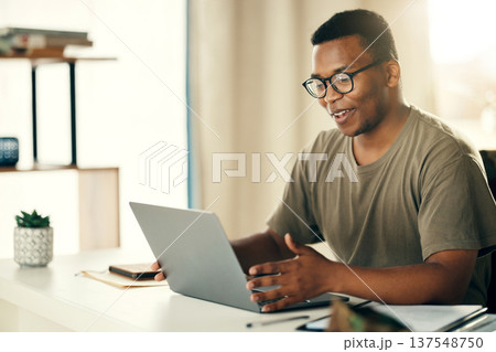 Laptop, man and smile for remote work, research or copywriting in home office with happiness and glasses. Computer, employee and person working or reading project online with internet or connectivity 137548750