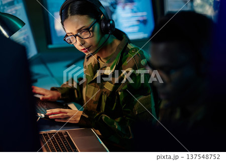 Military control room team, headset and woman with computer and tech for communication. Security, global surveillance info and soldier thinking in army office at government cyber data command center. 137548752