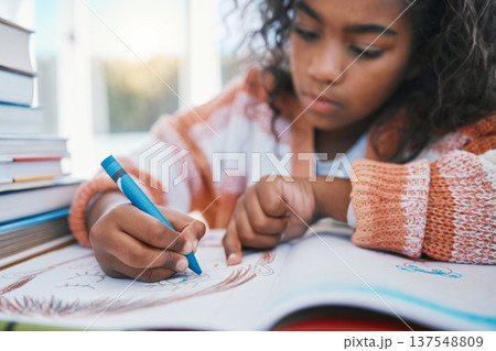 Education, homework and child coloring in a book for artistic project, assignment or fun. Colors, hobby and girl kid student writing for creative learning in a notebook by a desk at modern home. 137548809