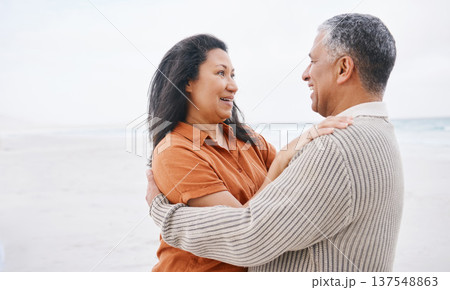 Beach, hug and senior happy couple love, support and care on travel holiday, retirement vacation and smile in outdoor nature. Eye contact, wellness and elderly man, old woman or marriage people bond 137548863
