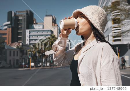 Coffee, travel and woman drink in city with trendy clothes for commute, walking and adventure. Relax, student and person with beverage, drinking and tea in town street for holiday, break and weekend 137548963
