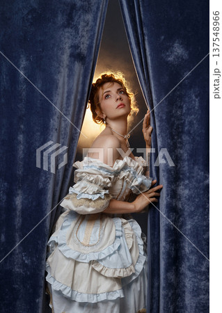 Actress Gazes Upward. Elegant Actress Gazes Upwards With Longing And Gentle Illumination 137548966
