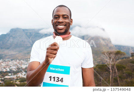 Runner man, winner and medal in portrait for marathon, competition or race with smile in Cape Town. African athlete guy, champion and success in challenge, contest and happy for metal prize in nature Runner man, winner and medal in portrait for marathon, competition or race with smile in Cape Town. African athlete guy, champion and success in challenge, contest and happy for metal prize in nature 137549048