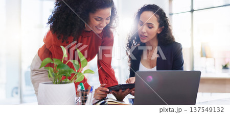 Teamwork, tablet and business women in office helping coworker with project. Coaching laptop, collaboration and intern in training talking to mentor with touchscreen technology in company workplace. Teamwork, tablet and business women in office helping coworker with project. Coaching laptop, collaboration and intern in training talking to mentor with touchscreen technology in company workplace. 137549132