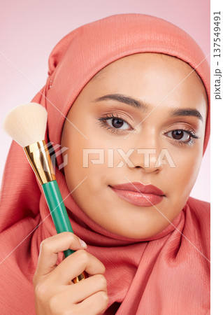 Makeup, brush tool and muslim woman portrait with a smile from cosmetics and blush in studio. Facial, glow and happy female person with beauty, skincare and shine with a hijab and skin for face Makeup, brush tool and muslim woman portrait with a smile from cosmetics and blush in studio. Facial, glow and happy female person with beauty, skincare and shine with a hijab and skin for face 137549491