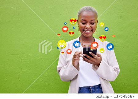 Phone icon, black woman and social media emojis of heart, thumbs up and smile for mockup advertising space. Cellphone, like opinion notification and user typing communication on green background wall 137549567